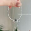 Lắc tay nơ đá phong thuỷ 13 z7858217557447 c0ca1661b0362808b7b0d83ff9e9179e